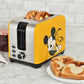 Mickey and Pluto 2-Slice Toaster in yellow shown in a lifestyle photo in kitchen with toast and jelly DSC-23 Select Brands