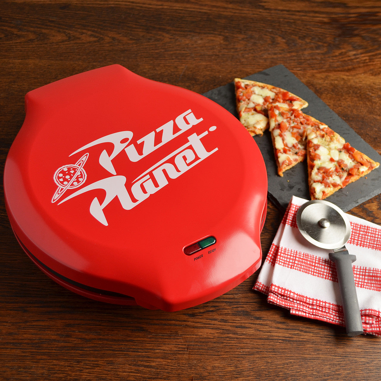 Pixar Toy Story Pizza Planet electric pizza maker lifestyle photo with pizza DTS-55 Select Brands