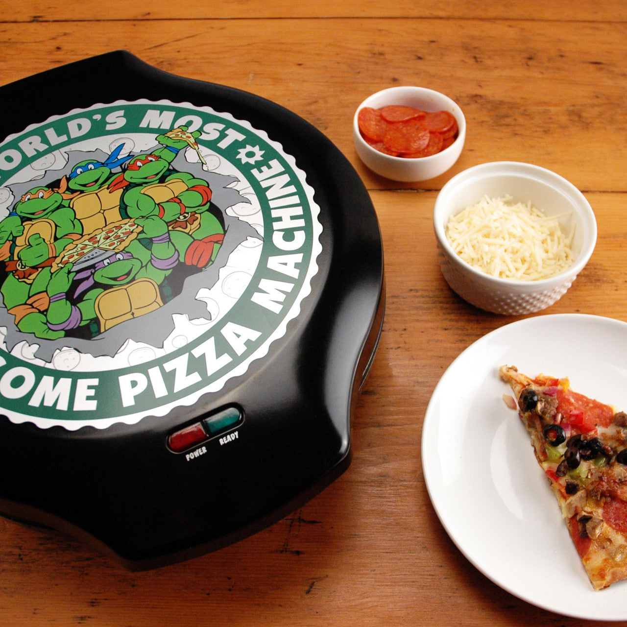 Nickelodeon Teenage Mutant Ninja Turtles pizza maker with slice of pizza on the plate NTPM-55 Select Brands